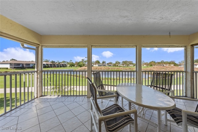 sunroom / solarium with a wealth of natural light and a water view