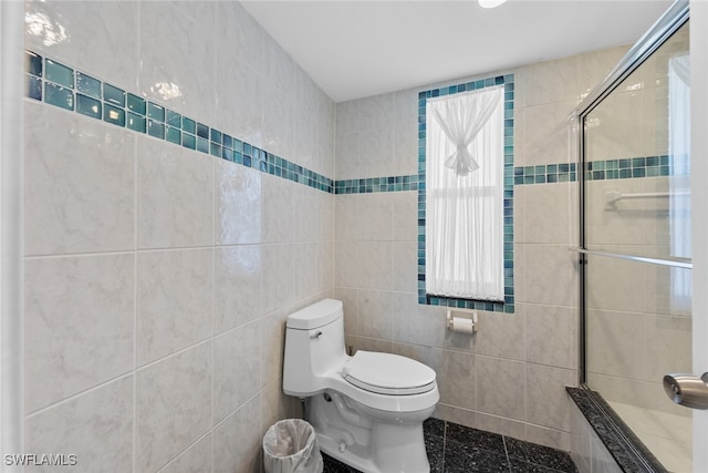 bathroom with an enclosed shower, tile walls, and toilet