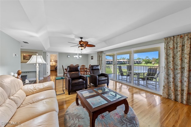 living room with ceiling fan and light hardwood / wood-style floors