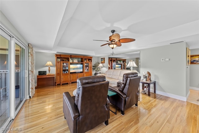 living room with ceiling fan and light hardwood / wood-style floors