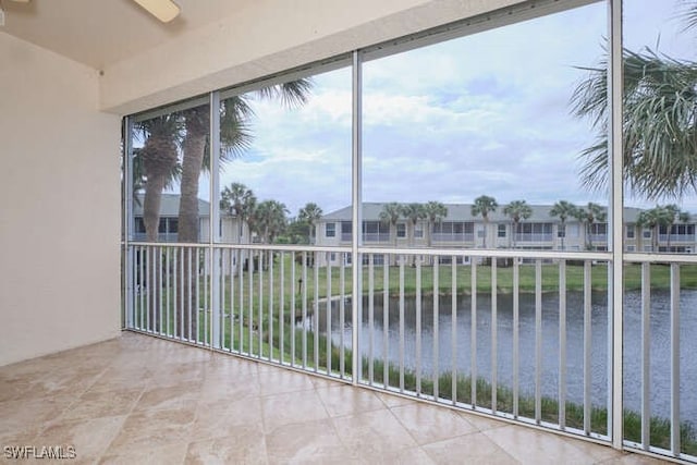 unfurnished sunroom with a water view