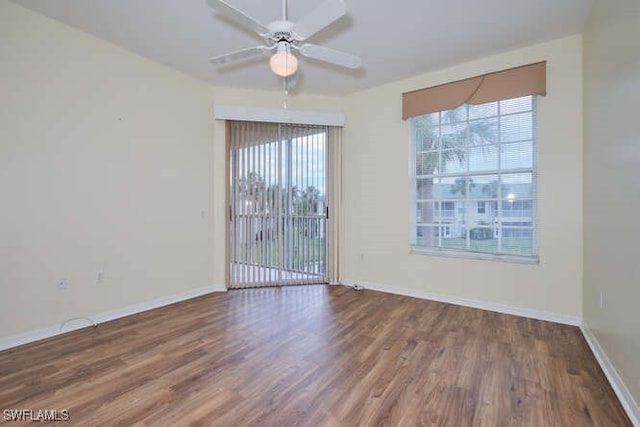 empty room with ceiling fan, hardwood / wood-style floors, and a healthy amount of sunlight