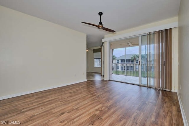 spare room with ceiling fan, baseboards, and wood finished floors