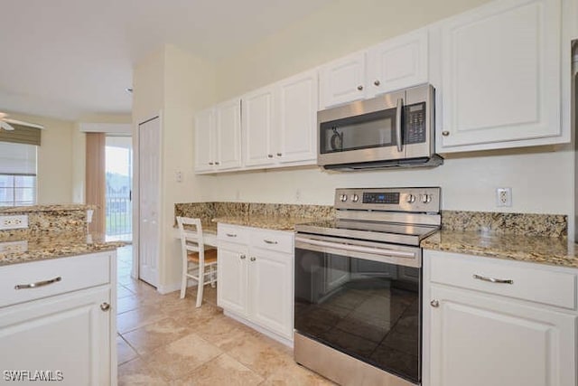 kitchen featuring light stone countertops, white cabinetry, and appliances with stainless steel finishes