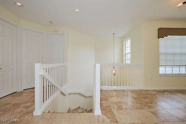 unfurnished room with baseboards