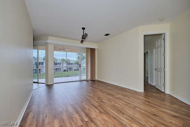 empty room with hardwood / wood-style floors