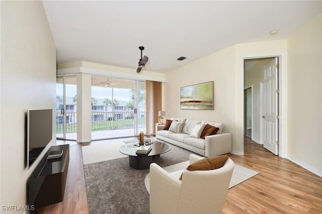 living room with ceiling fan and light hardwood / wood-style floors