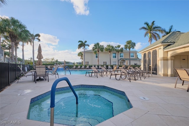 view of pool featuring a patio and a hot tub