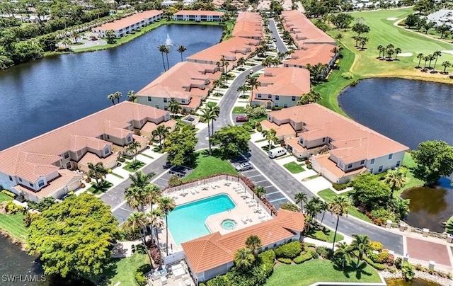 drone / aerial view featuring a water view and a residential view