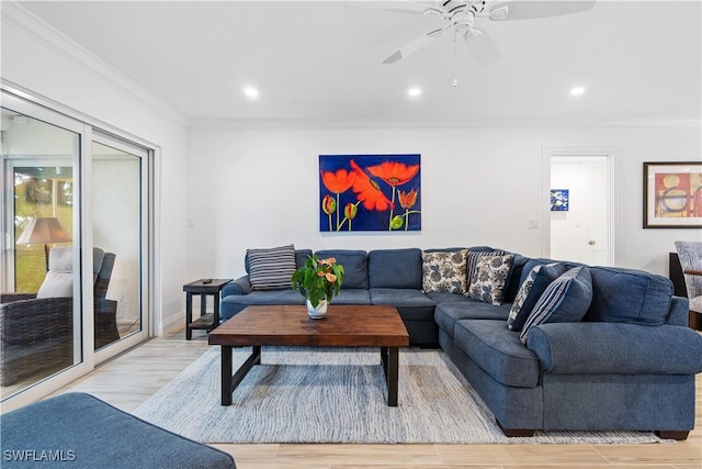 living room featuring ceiling fan, crown molding, and light hardwood / wood-style flooring