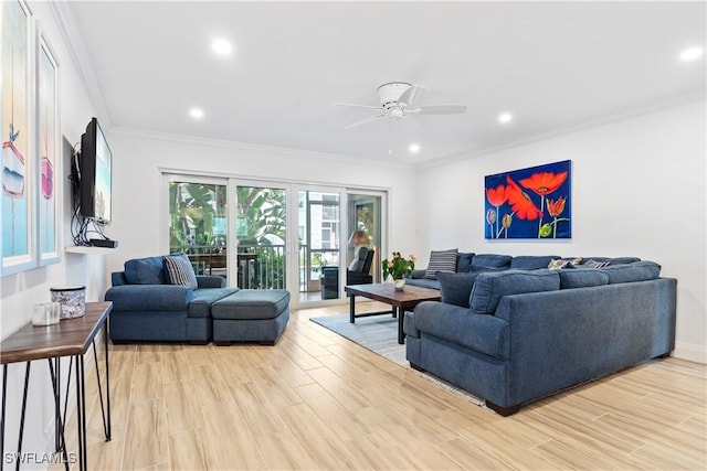 living room with ceiling fan, crown molding, and light hardwood / wood-style floors