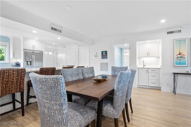 dining space with ornamental molding