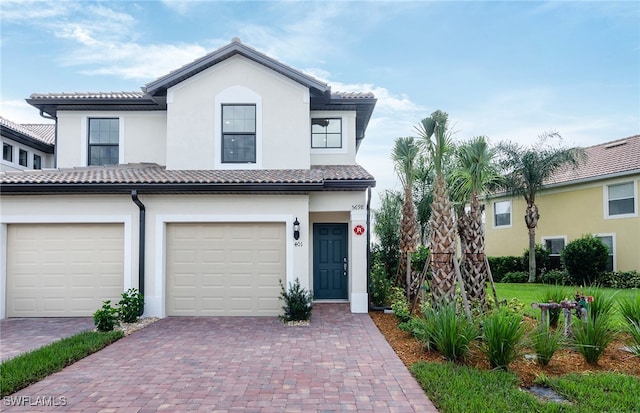 mediterranean / spanish-style house with a garage