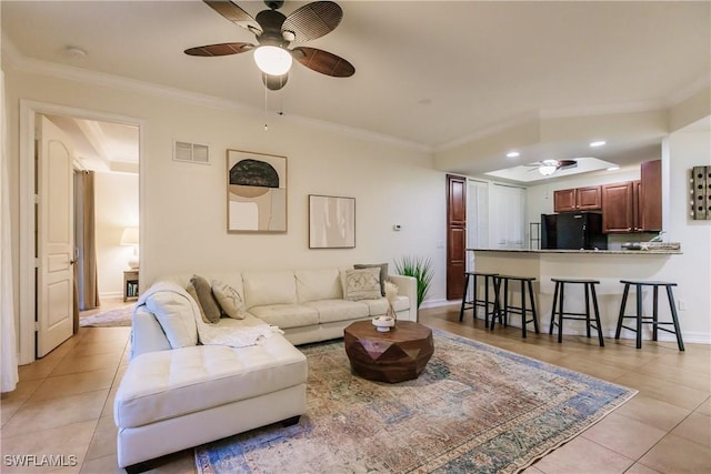 living room featuring ceiling fan, light tile patterned flooring, and crown molding