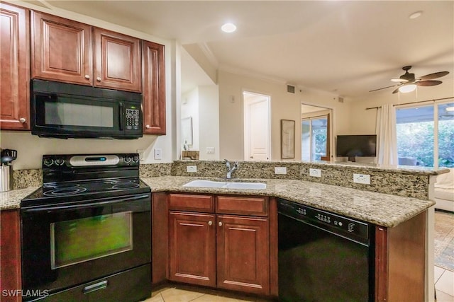 kitchen featuring kitchen peninsula, sink, light stone countertops, and black appliances