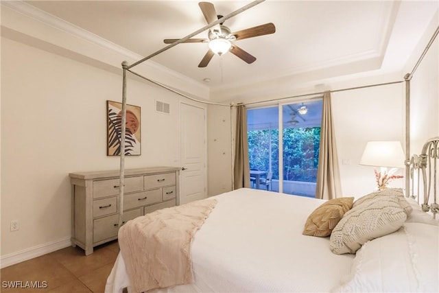 bedroom featuring ornamental molding, access to outside, a tray ceiling, ceiling fan, and light tile patterned floors