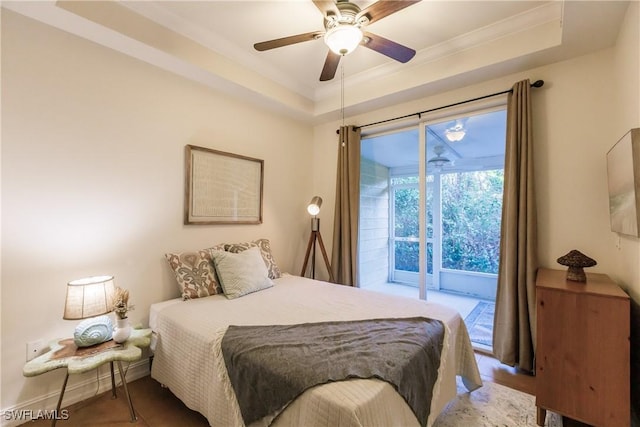 bedroom with access to outside, a tray ceiling, ceiling fan, and crown molding