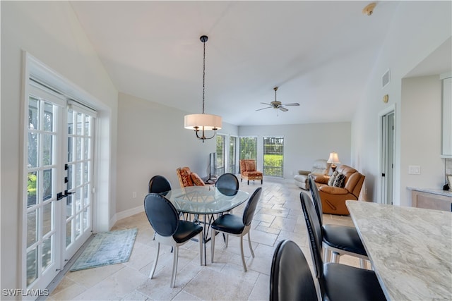 dining space featuring ceiling fan, french doors, and lofted ceiling