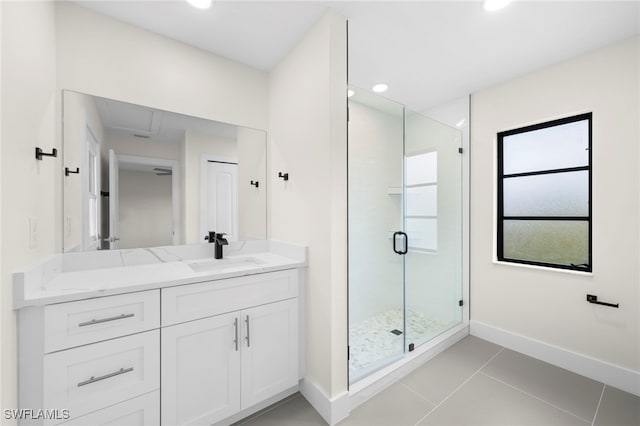 bathroom with tile patterned floors, vanity, and walk in shower