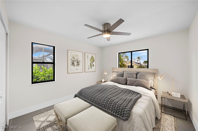 bedroom with tile patterned floors, ceiling fan, and a closet