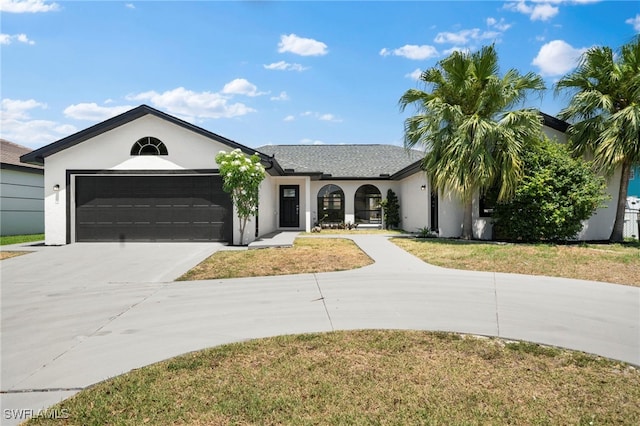 ranch-style home with a garage and a front yard