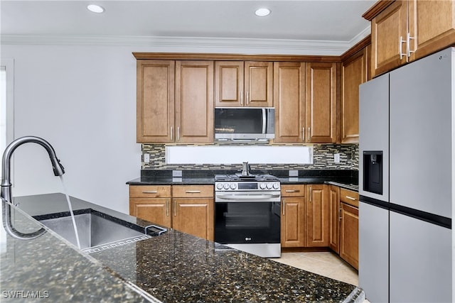 kitchen with ornamental molding, gas range, sink, light tile patterned floors, and white fridge with ice dispenser