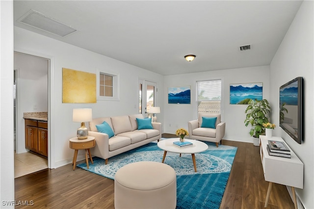 living room with dark hardwood / wood-style flooring and a baseboard radiator