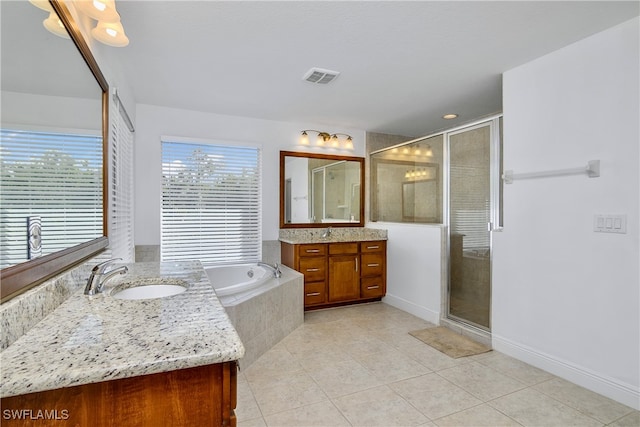 bathroom with tile patterned flooring, vanity, and independent shower and bath