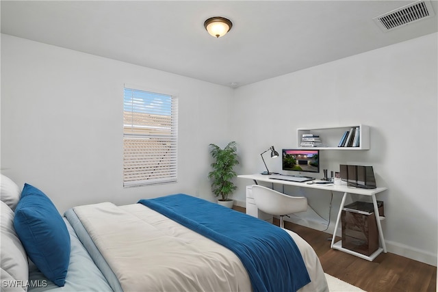 bedroom with dark hardwood / wood-style flooring