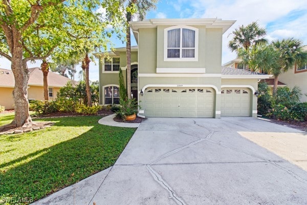 front facade with a garage and a front lawn