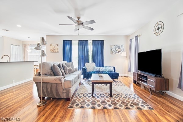 living room with ceiling fan, a healthy amount of sunlight, and wood-type flooring