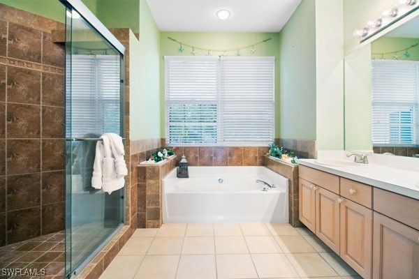 bathroom featuring a healthy amount of sunlight, shower with separate bathtub, and tile walls