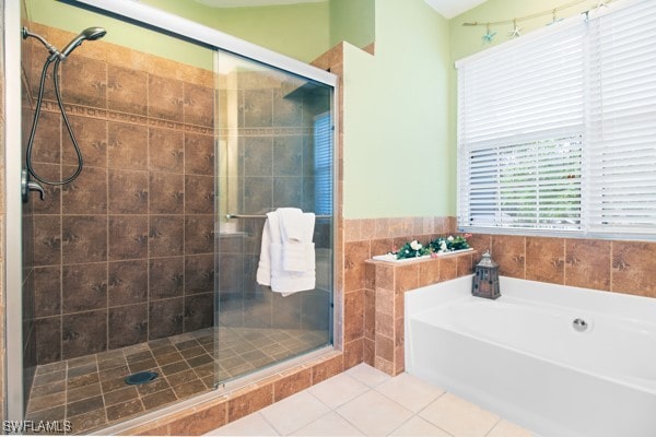 bathroom featuring tile patterned flooring and plus walk in shower