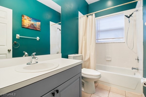 full bathroom featuring toilet, vanity, tile patterned floors, and shower / bath combo with shower curtain