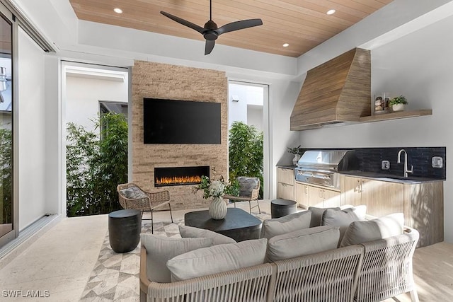 living area featuring wood ceiling, an outdoor stone fireplace, recessed lighting, and ceiling fan
