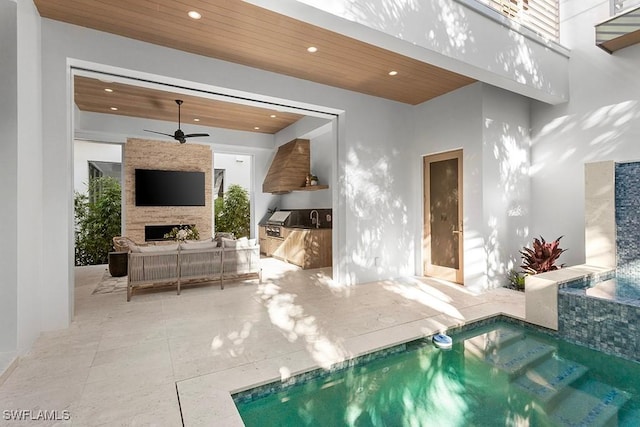 indoor pool with ceiling fan and a fireplace
