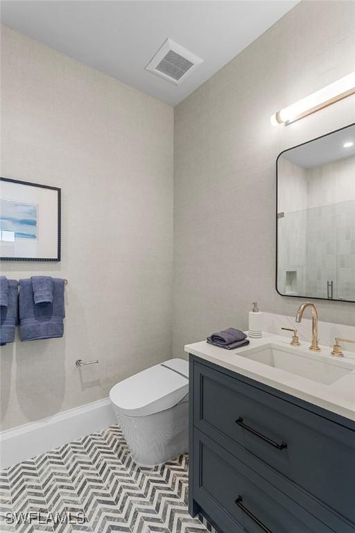 bathroom with toilet and vanity