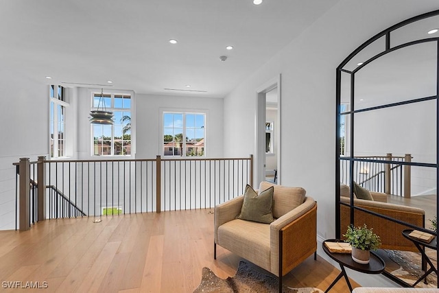 living area featuring wood finished floors, an upstairs landing, and recessed lighting