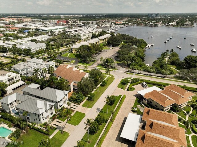 aerial view of property and surrounding area featuring a large body of water