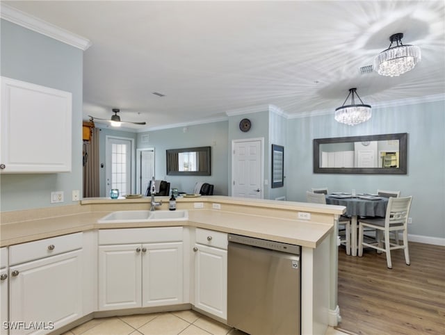 kitchen with dishwasher, kitchen peninsula, hanging light fixtures, and white cabinets