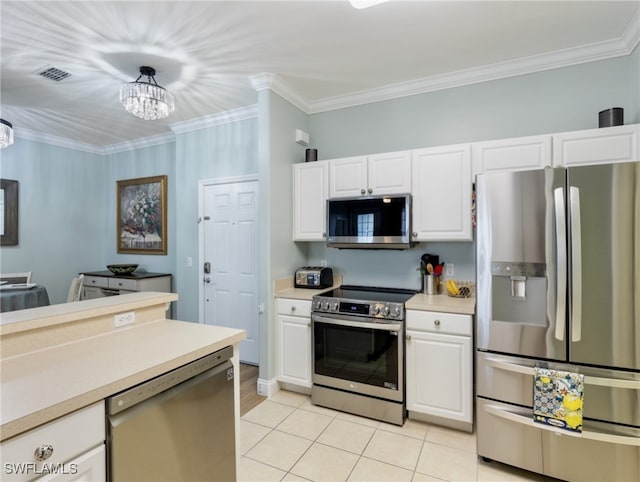 kitchen with hanging light fixtures, a notable chandelier, crown molding, white cabinetry, and appliances with stainless steel finishes