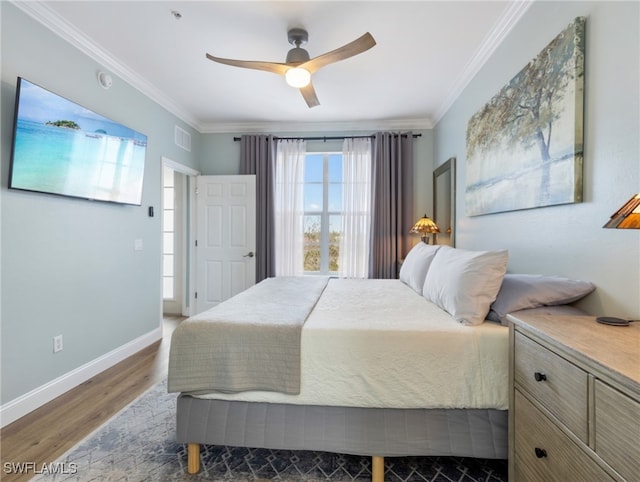 bedroom with ceiling fan, dark hardwood / wood-style floors, and crown molding