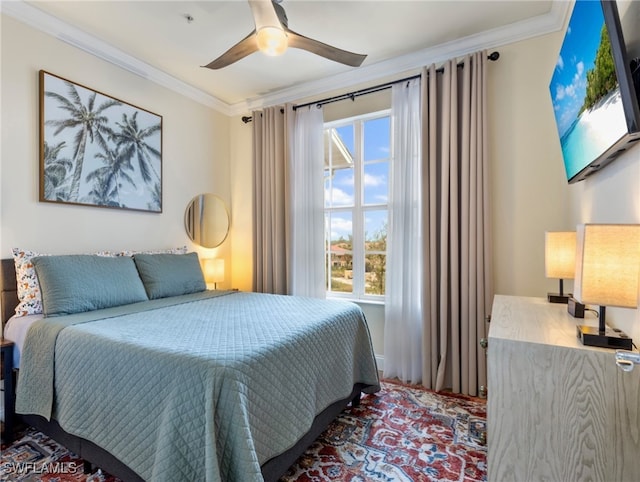 bedroom featuring ceiling fan, multiple windows, and crown molding