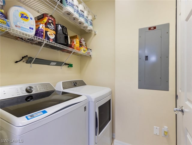 clothes washing area featuring electric panel and separate washer and dryer