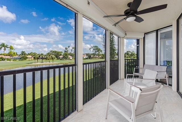 413 Augusta Blvd Unit 205, Naples, FL 34113 - sunroom / solarium featuring a ceiling fan, a water view, and view of golf course