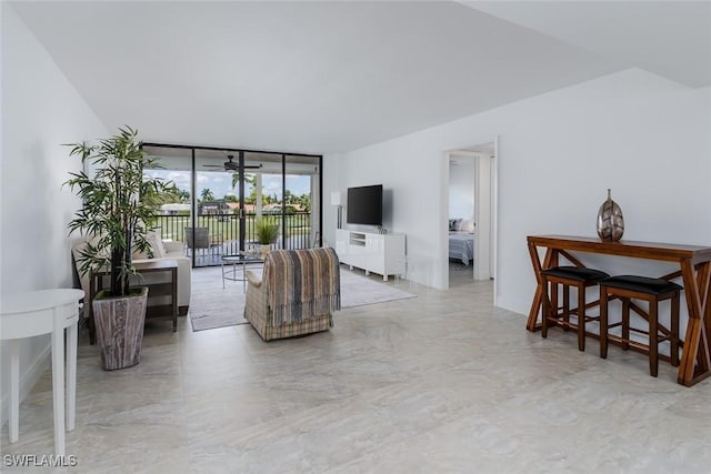 413 Augusta Blvd Unit 205, Naples, FL 34113 - living area featuring floor to ceiling windows and marble look tiles