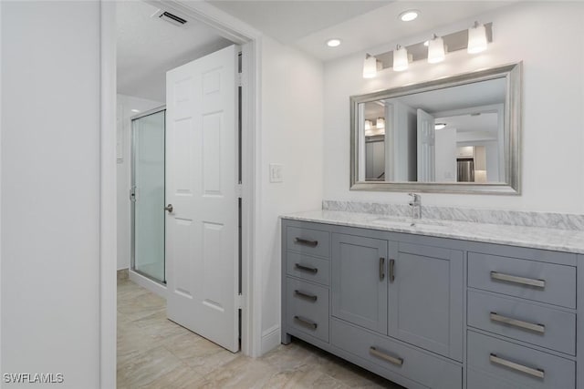 413 Augusta Blvd Unit 205, Naples, FL 34113 - bathroom featuring vanity, a stall shower, baseboards, recessed lighting, and marble look tiles