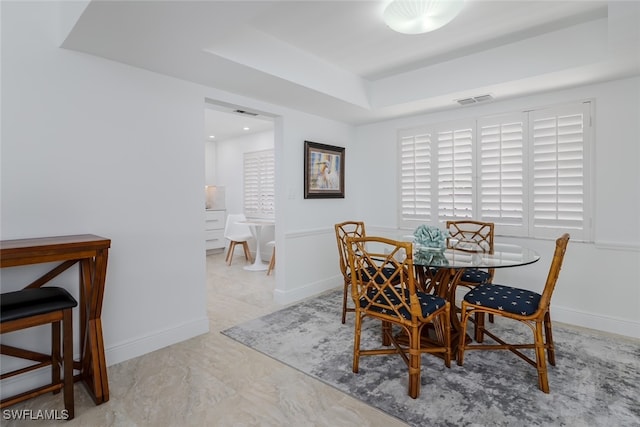 dining room with a tray ceiling