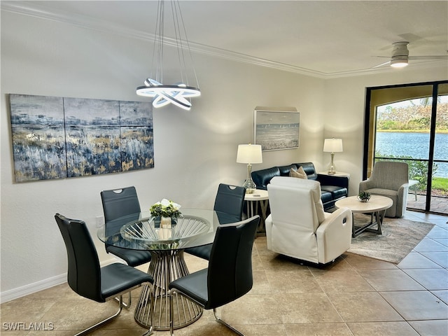 tiled dining room with ceiling fan and crown molding