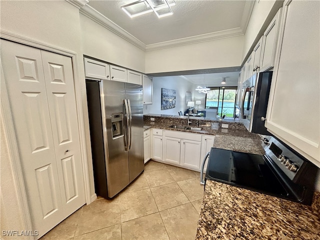 kitchen featuring ornamental molding, appliances with stainless steel finishes, light tile patterned floors, sink, and white cabinets